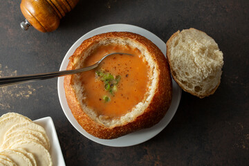 A top down view of a bread bowl of lobster bisque.