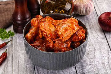 Raw marinated buffalo chicken wings