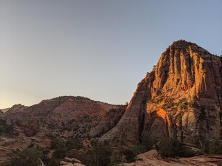 Sunrise Over Zion Canyon with Golden Light Flowing Through the Canyon Walls, Various Greenery of Early Spring May Landscape, and River Below