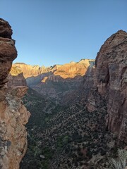 Sunrise Over Zion Canyon with Golden Light Flowing Through the Canyon Walls, Various Greenery of Early Spring May Landscape, and River Below