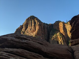 Obraz premium Sunrise Over Zion Canyon with Golden Light Flowing Through the Canyon Walls, Various Greenery of Early Spring May Landscape