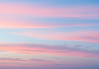 Panoramic sky view with soft pastel colors and wispy clouds creating a serene and dreamy atmosphere during sunset.

