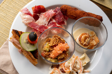 Close up of fingerfood and Spanish food of buffet on plate in restaurant Spain