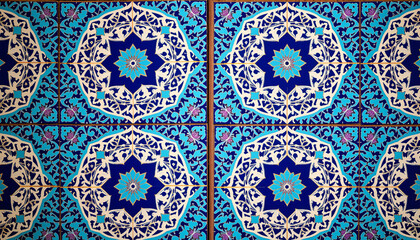 Traditional Arabian courtyard tilework featuring intricate geometric patterns in blue and turquoise