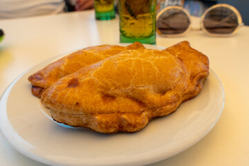freshly baked empanadas pasties with different fillings for sale Murcia Spain