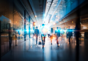Blurred figures moving through a bright, commercial space in Hong Kong.  An active business environment with motion and urban energy is conveyed.