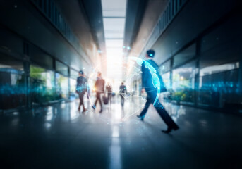 Blurred image of people in suits walking through a modern building in Hong Kong.