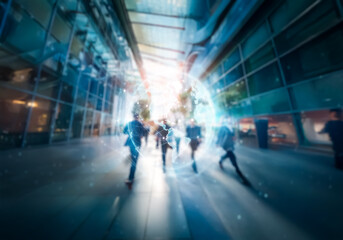 A blurry view of people walking through a modern glass building.