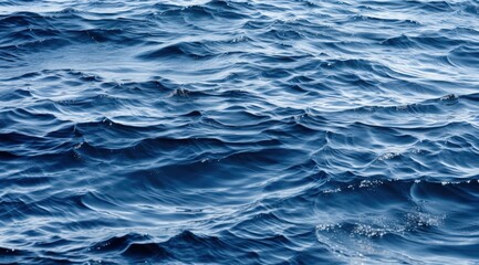 Obraz premium Serene ocean waves ripple, conveying peace, power, and a vast expanse in blue depths. Stock image use