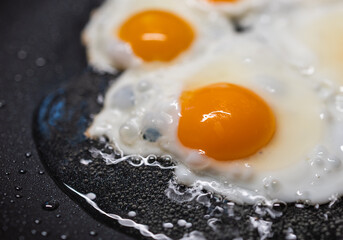 Fried eggs on frying pan