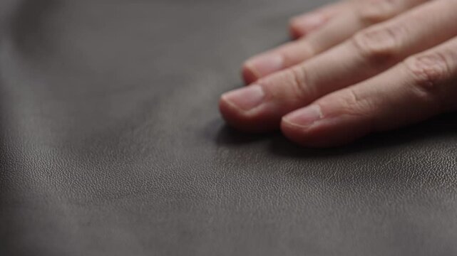 Slide shot man touching fine leather closeup