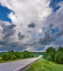 Road with trees in the background and a cloudy sky