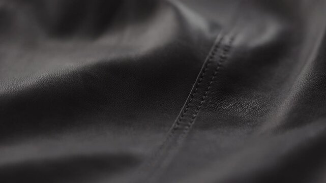 Slow motion handheld shot of soft gray brown leather closeup