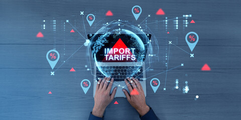 Import tariffs increase concept with digital graphics and laptop.