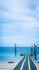 plastic pier in the sea with blue sky in vertical