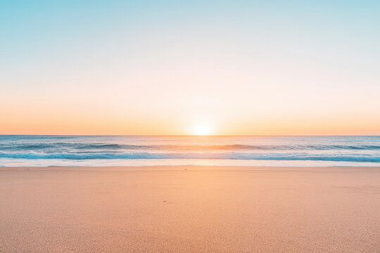 Golden Sunrise Over a Pristine Beach with Gentle Ocean Waves