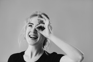 Cheerful Young Woman Displaying Optimism and Enjoyment in a Black and White Portrait