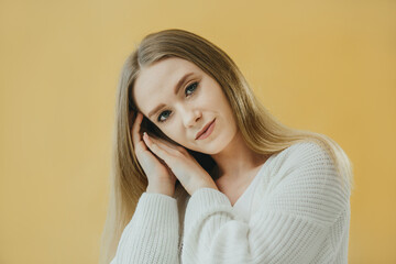 Portrait of a Thoughtful Woman Posing Against a Yellow Background