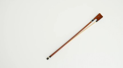 Violin Bow Resting Diagonally on White Surface