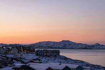 Nuuk the capital of Greenland.  Beautiful colored houses by the sea with snow and Christmas lights at sunset  © Sarah Østergaard