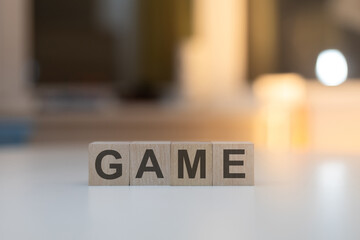 Wooden Cubes on the Table with Game Written on Them