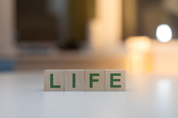 Wooden Cubes on the Table with LIFE Written on Them