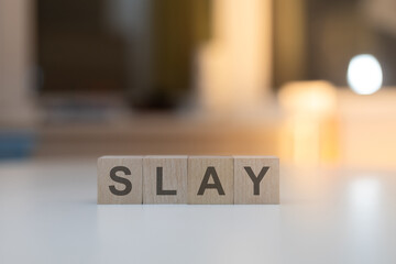 Wooden Cubes on the Table with SLAY Written on Them