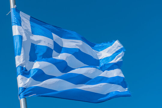 The Greek flag with blue sky.