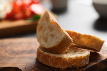 Slices of ciabatta bread on olive board