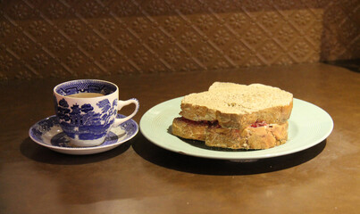 A Traditional Cup of Tea and a Jam Bread Sandwich.