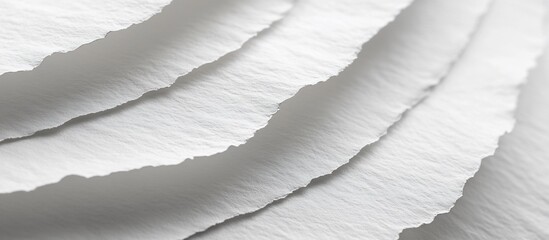 Close-up view of textured white paper sheets layered elegantly, showcasing subtle shadows