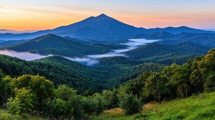 Obraz premium Majestic Mountain Landscape at Sunrise with Lush Green Hills and Misty Valleys in Background