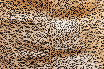 Leopard skin background.  Tanned leather stretched on the wall. Horizontally. 