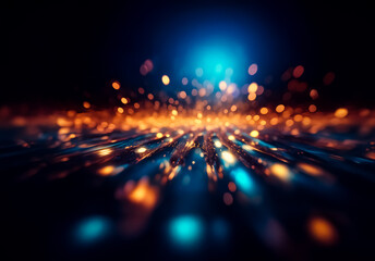 Abstract blurry lights in orange and blue hues create a dynamic and energetic effect against a dark backdrop.  The image evokes a sense of motion and abstract illumination.