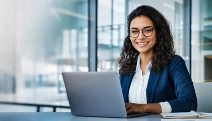 Smiling portrait professional it specialist latin hispanic business lady working on laptop pc sitting in modern office. Young middle eastern indian woman using computer technology for work. Copy space