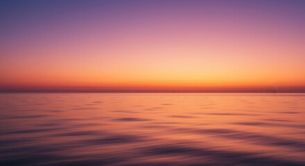 Obraz premium Calm Ocean at Sunset with Soft Orange and Purple Sky