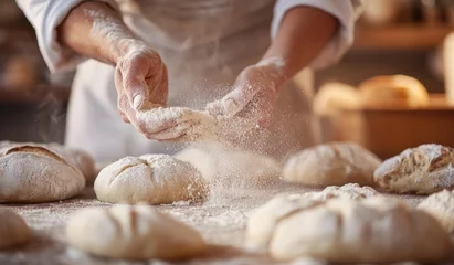 Fototapeten Baker shaping dough, bakery, flour dust, bread baking, food prep © kribbox