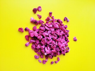 Pile of yummy raspberries on a yellow background.