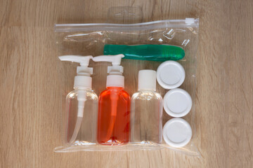  travel set of soap accessories in a transparent zip bag, inside of which is a toothbrush, shampoo, shower gel and jars of creams	
