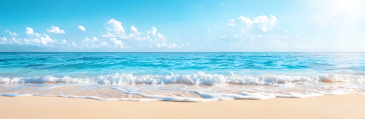 panoramic view of beautiful turquoise sea with waves gently lapping sandy beach under clear blue sky