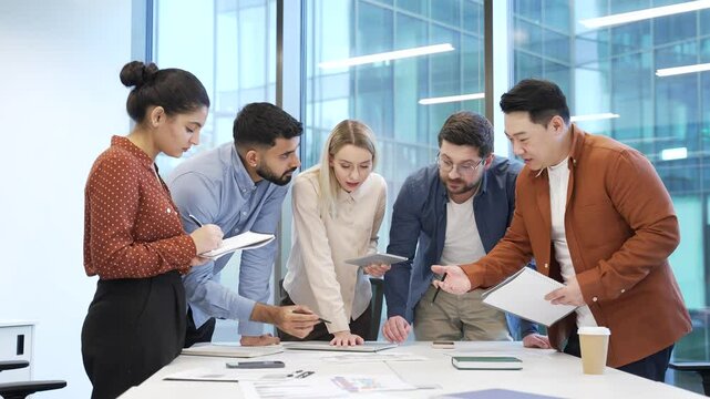 Group of business people communicate at meeting in office. Team of professionals discussing startup strategy, engaging in decision making, collaboration on work project, engaged brainstorming teamwork