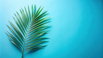 Fototapeta premium Vibrant Green Palm Frond on a Bright Blue Background, Perfect for Summer Designs and Tropical Themed Projects
