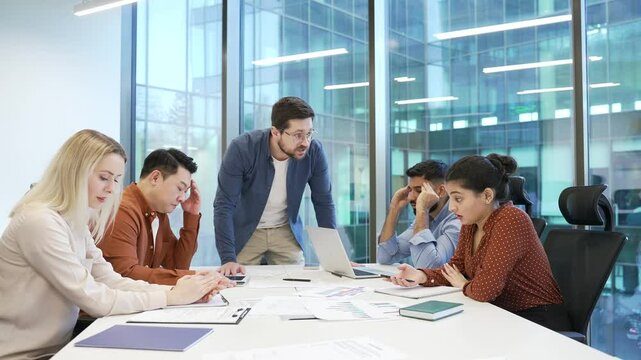 Angry boss quarreling with upset subordinate work result at conference in business office. Dissatisfied manager scolding incompetent workers. Furious CEO director arguing talking about problems