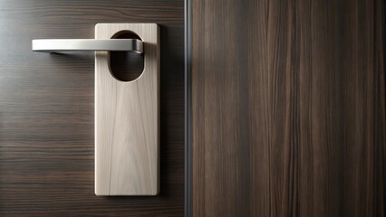 A Light Wood Do Not Disturb Sign on a Dark Wood Door Handle