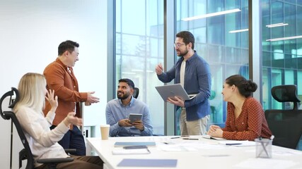 Group of happy business people communicate have a friendly chat during a coffee break at workplace in office. Colleagues enjoy fun cheerful discussing. Team of coworkers have a casual conversation