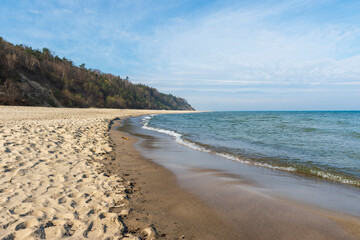 Sandy Beach and Cliffs with Waves in Jastrzębia Góra on a Sunny Spring Day