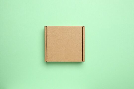 Cardboard box on green background