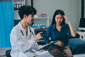 doctor consulting senior old patient filling form at consultation. Professional physician wearing white coat talking to mature woman signing medical paper at appointment visit in clinic.