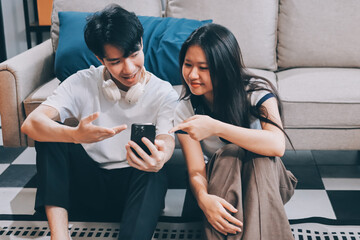 Smiling couple unpacking boxes in new house