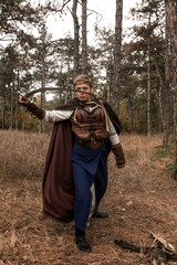 Fototapeta premium warrior girl with sword in hands in forest.